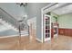 View of the light and airy foyer with wooden floors, staircase with iron railing, and view of the fireplace at 7949 S Blackstone Pkwy, Aurora, CO 80016