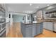 Open kitchen design with a large island, stainless appliances, and bright countertops at 7949 S Blackstone Pkwy, Aurora, CO 80016