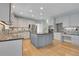 Kitchen with large island, grey cabinets, stainless steel appliances and stylish backsplash at 7949 S Blackstone Pkwy, Aurora, CO 80016