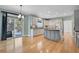 Kitchen with grey cabinetry, stainless steel appliances, and an island, adjacent to a patio door at 7949 S Blackstone Pkwy, Aurora, CO 80016