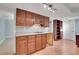 Basement kitchenette with wood cabinets, laminate countertops, and neutral walls and flooring at 7949 S Blackstone Pkwy, Aurora, CO 80016