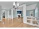 Open living room featuring hardwood floors, fireplace, and bright pillars at 7949 S Blackstone Pkwy, Aurora, CO 80016