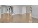 Spacious living room with hardwood floors, natural light, and stairway with iron railing at 7949 S Blackstone Pkwy, Aurora, CO 80016