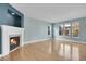 Bright living room with a fireplace, large windows, and beautiful hardwood floors at 7949 S Blackstone Pkwy, Aurora, CO 80016