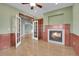 Living room boasting a cozy fireplace, hardwood floors, wainscotting and natural light from windows at 7949 S Blackstone Pkwy, Aurora, CO 80016
