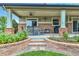 Covered outdoor patio features brick columns, ceiling fan, outdoor seating and barbeque at 7949 S Blackstone Pkwy, Aurora, CO 80016