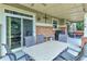 Covered outdoor patio with a ceiling fan, dining table, and a grill at 7949 S Blackstone Pkwy, Aurora, CO 80016