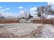 Fenced backyard with partial snow coverage, a shed, and parking in the rear at 3390 S Elm St, Denver, CO 80222