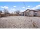 Spacious fenced backyard with partial snow coverage providing ample space at 3390 S Elm St, Denver, CO 80222