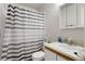 Compact bathroom with a single sink vanity, toilet, and shower-tub combo at 3390 S Elm St, Denver, CO 80222
