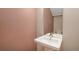 Minimalist bathroom with a pedestal sink, decorative mirror, and light fixtures at 4144 Tennyson St # 10, Denver, CO 80212
