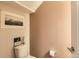 Half bathroom showcasing a toilet, framed art, and a light-colored wall at 4144 Tennyson St # 10, Denver, CO 80212