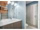 Modern bathroom featuring wood vanity, shower with glass enclosure, and modern fixtures at 4144 Tennyson St # 10, Denver, CO 80212