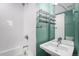 Bathroom with tub and shower featuring white subway tile and floating shelves at 4144 Tennyson St # 10, Denver, CO 80212