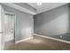 Bedroom with en-suite bathroom featuring neutral walls, carpet, and natural light at 4144 Tennyson St # 10, Denver, CO 80212
