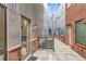 Modern exterior with brick and metal accents, showing a walkway leading to residential units at 4144 Tennyson St # 10, Denver, CO 80212