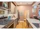 Modern kitchen with stainless steel appliances, quartz countertops, and wooden cabinets at 4144 Tennyson St # 10, Denver, CO 80212