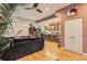 Open-concept living room with hardwood floors flowing into a modern kitchen and comfortable seating at 4144 Tennyson St # 10, Denver, CO 80212