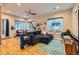 Well-lit living room with hardwood floors, a comfortable sofa, and large windows offering ample natural light at 4144 Tennyson St # 10, Denver, CO 80212