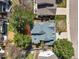 Aerial view of home with fenced yard, mature trees, and deck at 9408 Harvard Dr, Highlands Ranch, CO 80130