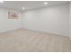 Finished basement area with neutral carpet, recessed lighting, and simple wall decor at 9408 Harvard Dr, Highlands Ranch, CO 80130