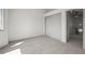 Bright bedroom with neutral carpet, large closet, and view to the second story loft at 9408 Harvard Dr, Highlands Ranch, CO 80130