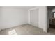 Carpeted bedroom with closet and door to bathroom at 9408 Harvard Dr, Highlands Ranch, CO 80130