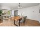 Dining room with a wooden table, stylish chairs, and views into the living area at 9408 Harvard Dr, Highlands Ranch, CO 80130