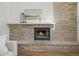 A brick fireplace in a living room with a gray sofa at 9408 Harvard Dr, Highlands Ranch, CO 80130