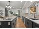 Long kitchen has dual islands and sinks that lead to the living room with fireplace at 9408 Harvard Dr, Highlands Ranch, CO 80130