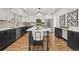 Modern kitchen with stainless steel appliances, dark cabinets, white countertops, and a stylish island at 9408 Harvard Dr, Highlands Ranch, CO 80130