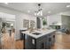 Kitchen island offers seating and a view of the living room and fireplace in an open concept layout at 9408 Harvard Dr, Highlands Ranch, CO 80130
