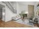 Bright living room featuring a brick fireplace, modern staircase, and hardwood floors at 9408 Harvard Dr, Highlands Ranch, CO 80130