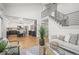 Spacious living area with high ceilings open to kitchen with island and staircase with metal railing at 9408 Harvard Dr, Highlands Ranch, CO 80130