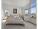 This bright main bedroom features ample natural light and neutral tones with two large windows at 9408 Harvard Dr, Highlands Ranch, CO 80130