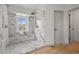 Luxurious walk-in shower boasts marble walls, a bench, and stylish fixtures, creating a spa-like experience at 9408 Harvard Dr, Highlands Ranch, CO 80130
