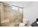 Bathroom featuring glass enclosed walk-in shower with tile surround, bench, and modern fixtures at 1632 S Josephine St, Denver, CO 80210