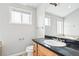 Bright bathroom featuring a large vanity with black countertops, a toilet, and a large mirror at 1632 S Josephine St, Denver, CO 80210