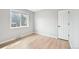 Bright bedroom with light hardwood floors and a large window at 1632 S Josephine St, Denver, CO 80210