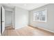 Bedroom with light hardwood floors and a large window that provides plenty of natural light at 1632 S Josephine St, Denver, CO 80210