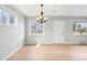 Bright dining room with hardwood floors, modern lighting, and a view of the front yard at 1632 S Josephine St, Denver, CO 80210