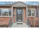 Close-up of the front porch with brick siding and a covered entrance with house number at 1632 S Josephine St, Denver, CO 80210
