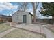 Exterior view of the detached garage with a gray paint finish and a brick paver path at 1632 S Josephine St, Denver, CO 80210