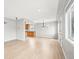 Open-concept living room with hardwood floors and views into the dining area and kitchen at 1632 S Josephine St, Denver, CO 80210