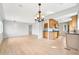 Open concept living room flows into a kitchen with stainless steel appliances and light hardwood floors at 1632 S Josephine St, Denver, CO 80210