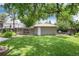 Backyard with a shed, a grassy area, a gardening bed and a fire pit at 3061 S Marion St, Englewood, CO 80113