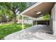 Spacious backyard with lush green grass, a covered patio, and mature trees, perfect for outdoor entertaining at 3061 S Marion St, Englewood, CO 80113