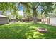 Spacious backyard featuring a gardening enclosure, a firepit and a shed at 3061 S Marion St, Englewood, CO 80113