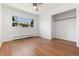 Clean and bright bedroom featuring hardwood floors, ceiling fan, and closet at 3061 S Marion St, Englewood, CO 80113