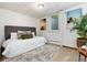 Bedroom features a neutral color palette, carpet, and natural light at 3061 S Marion St, Englewood, CO 80113